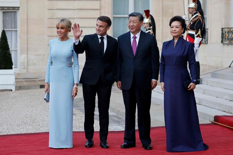 Mr Macron, Ms Macron, Mr Xi and Ms Peng at the steps of the Elysee Palace. AFP