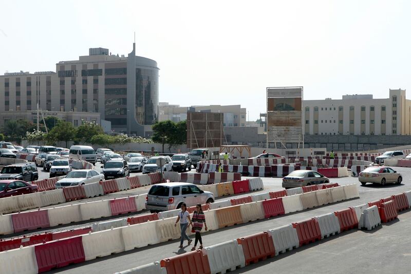 Dubai, United Arab Emirates - September 10, 2013.  Traffic building up as early as 8:30 am in this small temporary roundabout at the back of the JLT towers but slowly improving due to securities or traffic enforcers around the area, road construction in JLT is still ongoing.   ( Jeffrey E Biteng / The National )  Editor's Note;  Caline M reports. *** Local Caption ***  JB100913-Traffic10.jpg