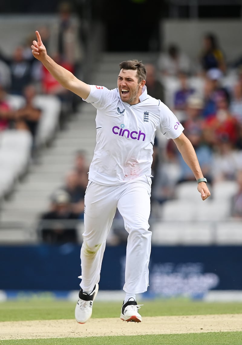 England bowler Jamie Overton celebrates taking the wicket of Tom Latham. Getty