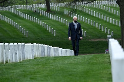 TOPSHOT - US President Joe Biden walks through Arlington National cemetary to honor fallen veterans of the Afghan conflict in Arlington, Virginia on April 14, 2021. President Joe Biden announced it's "time to end" America's longest war with the unconditional withdrawal of troops from Afghanistan, where they have spent two decades in a bloody, largely fruitless battle against the Taliban. / AFP / Brendan SMIALOWSKI
