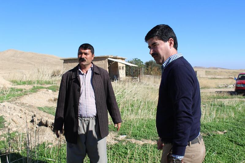 In the village of Khani, Hussein Kasim Hassoon, left, who heads efforts by the Kurdish Regional Government to document ISIL’ crimes against the Yazidis, is standing next to Said Khader Faris, whose parents executed by the extremists. Florian Neuhof for The National