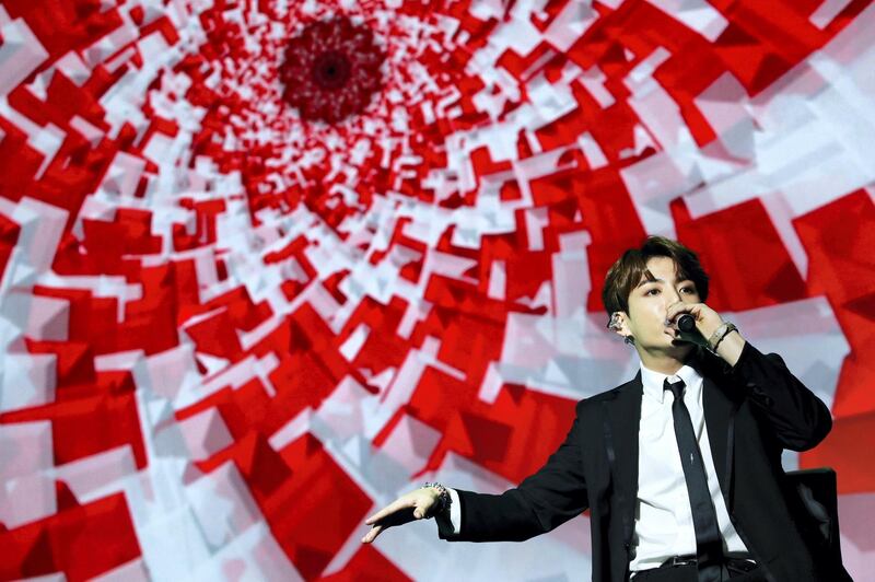 A member of South Korean pop group BTS performs during a Korean cultural event as part of South Korean President official visit in France, on October 14, 2018 in Paris. (Photo by YOAN VALAT / POOL / AFP)