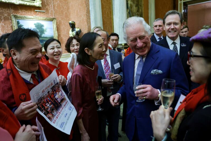 King Charles shares a joke with guests at the Buckingham Palace reception. AP