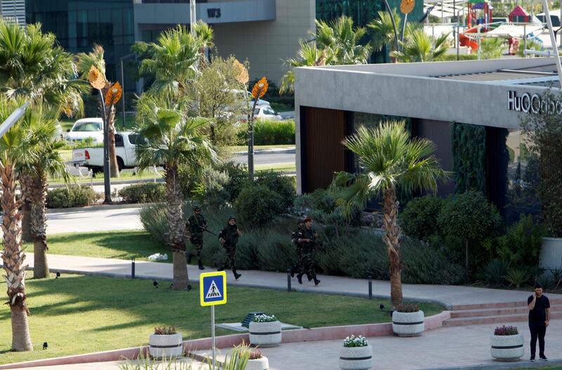 Kurdish security members are seen near a restaurant where Turkish diplomats and Turkish consulate employee were killed in Erbil, Iraq July 17, 2019.  REUTERS/Azad Lashkari