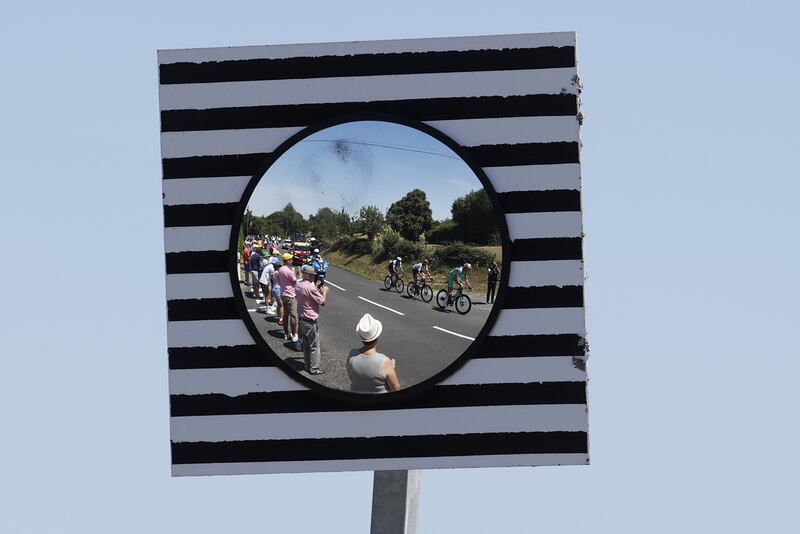 Spectators watch, left to right,  Quick-Step Alpha Vinyl Team's Mikkel Honore, Nils Politt of Bora Hansgrohe and Jumbo Visma's Wout Van Aert during Stage 15. EPA
