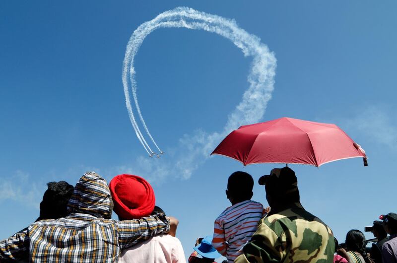 Spectators watch The Yakovlevs, a UK based aerobatic team, perform aerobatic maneuvres on the last day of Aero India 2019 at Yelahanka air base in Bangalore, India. AP Photo