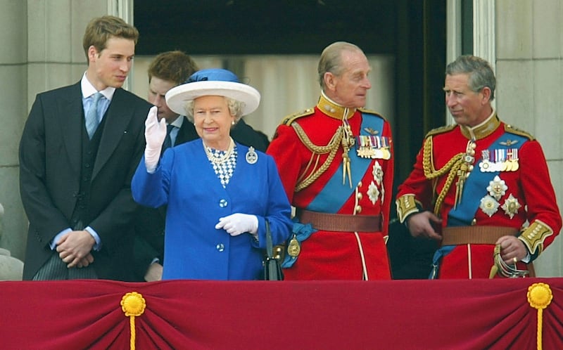 Queen Elizabeth  waves to the crowd from the balcony of Buckingham Palace in 2003
