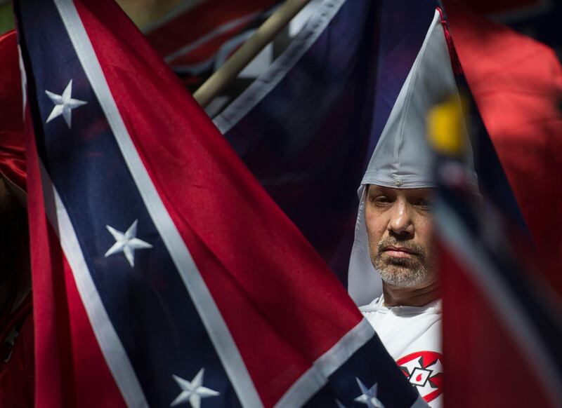 (FILES) This file photo taken on July 08, 2017 shows a member of the Ku Klux Klan during a rally, calling for the protection of Southern Confederate monuments, in Charlottesville, Virginia.
A sizeable contingent of members of the extreme right and white nationalists are expected to descend on a small US university town on August 12, 2017 -- and a fierce opposition front is uniting against it.Thousands of white nationalists, including supporters of the Ku Klux Klan white supremacist group, and anti-fascist activists are expected to clash in Charlottesville, Virginia, a sleepy town planning to remove a statue of General Robert E. Lee, who led Confederate forces in the US Civil War.
 / AFP PHOTO / ANDREW CABALLERO-REYNOLDS
