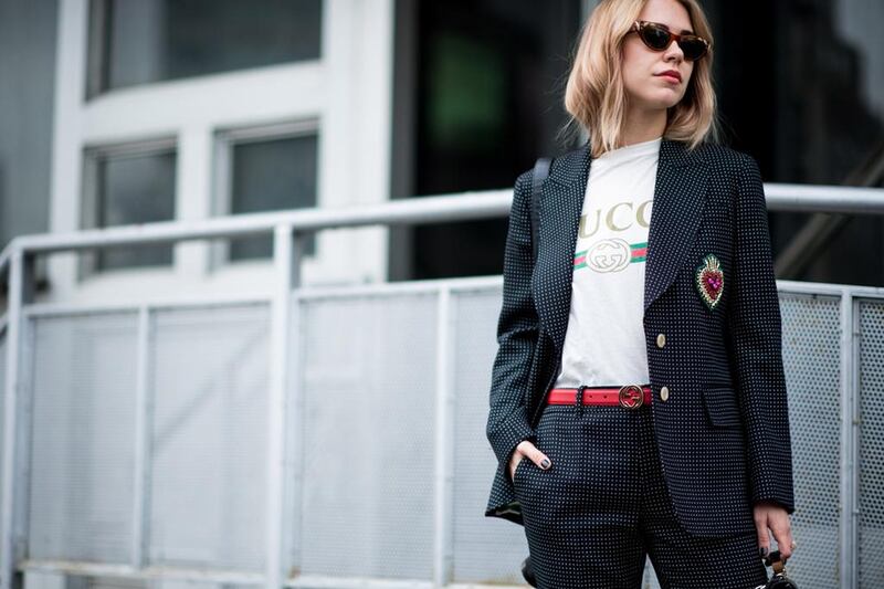 A guest at London Fashion Week wearing the Gucci T-shirt with a matching suit set and colourful accessories. Courtesy of Net-a-Porter