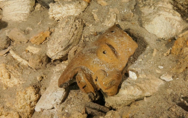 A piece of a broken mask on the cave floor inside the Sac Actun underwater cave system. Mexican experts said the recently mapped Sac Actun cave system "is probably the most important underwater archaeological site in the world." Great Mayan Aquifer Project-INAH via AP