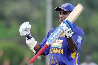 Sri Lankan cricketer Sanath Jayasuriya raises his bat in the air to celebrate scoring a century (100 runs) during the first One Day International (ODI) match between India and Sri Lanka at the Rangiri Dambulla International Cricket stadium in Dambulla, some 150 kms north of Colombo on January 28, 2009. India captain Mahendra Singh Dhoni elected to field after winning the toss against Sri Lanka in the opening one-day international. AFP PHOTO/Lakruwan WANNIARACHCHI (Photo by LAKRUWAN WANNIARACHCHI / AFP)