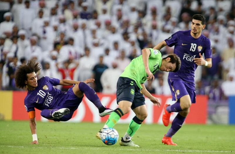 Al Ain midfielder Omar Abdulrahman, left, flies into tackle during the Asian Champions League final second leg. Pawan Singh / The National 