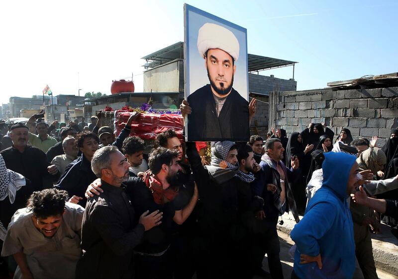 Mourners chant anti-government slogans while they carry the coffin of prominent social activist Wissam al-Ghrawi in Basra, Iraq, Sunday, Nov. 18, 2018. Iraqi police say religious cleric Wissam, who was linked to the ongoing protests over poor services in Basra, was killed outside his home after suggested that demonstrators should take up arms over the conditions in the city. (AP Photo/Nabil al-Jurani)