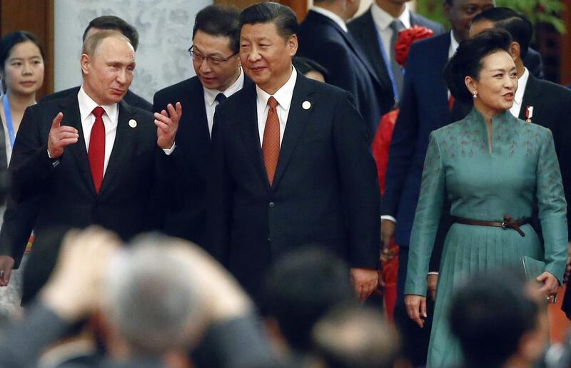 Chinese resident Xi Jinping, centre, his wife Peng Liyuan and Russian president Vladimir Putin, left, arrive for a welcome banquet for the Belt and Road Forum at the Great Hall of the People in Beijing on May 14, 2017. Wu Hong / Pool Photo via AP