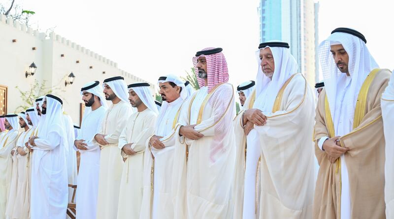 Sheikh Humaid bin Rashid Al Nuaimi, Ruler of Ajman, and Sheikh Ammar bin Humaid Al Nuaimi, Crown Prince of Ajman, perform Eid prayers. Wam