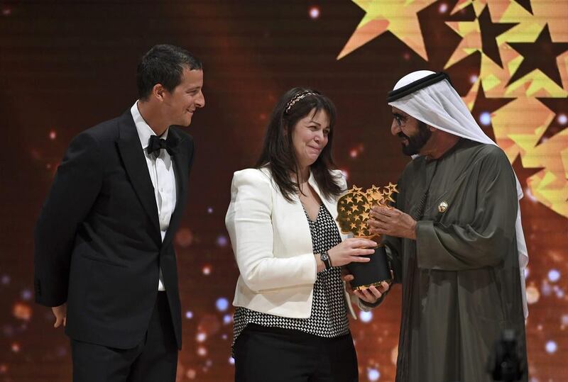 Sheikh Mohammed bin Rashid, Vice President and Ruler of Dubai, presented Maggie MacDonnell with the award on the final day of the Global Education and Skills Forum. Martin Dokoupil / AP Photo