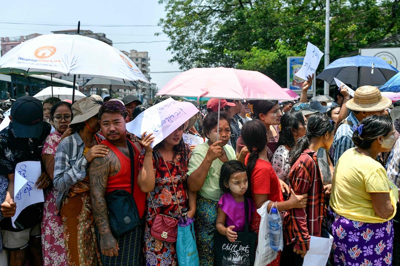 Relatives gather around a bus carrying prisoners released from Insein prison for the Buddhist New Year, in Yangon. AFP