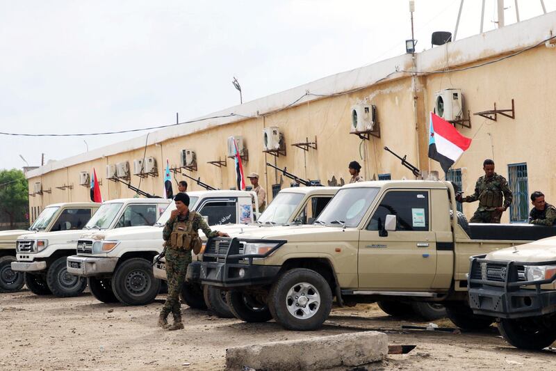 Security forces loyal to the separatist Southern Transitional Council stand next to vehicles as they are deployed in the southern port city of Aden, Yemen December 20, 2020. REUTERS/Fawaz Salman