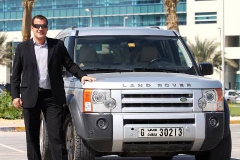 Abu Dhabi,  United Arab Emirates- October 30, 2011:  Sandy Stirling pose next to his Land Rover LR3  outside his office in Abu Dhabi. ( Satish Kumar / The National ) For Motoring