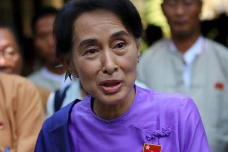 Myanmar democracy icon Aung San Suu Kyi is surrounded by NLD party officials as she meets with the media after being re-elected leader of the National League for Democracy (NLD) party during their first ever nationwide congress within 25 years, in Yangon, Myanmar.