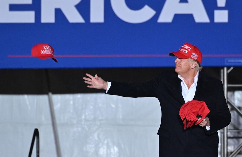 Mr Trump throws "Save America" caps to people at the rally at the Canyon Moon Ranch festival grounds in Florence, south-east of Phoenix. AFP