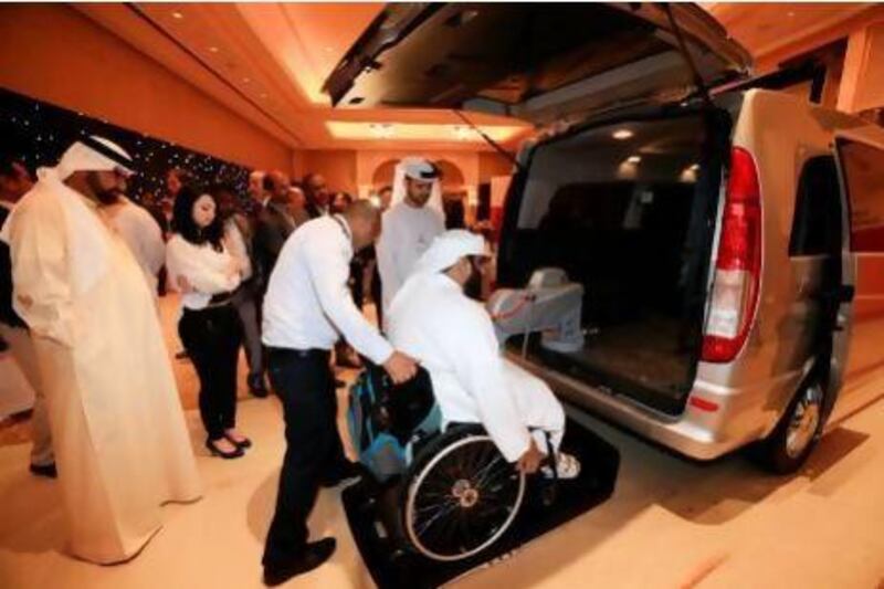 Driver Anil Kumar helps Abdullah Al Saad, a senior administrative officer with the Department of Transport, into one of the six Dh250,000 Mercedes vans, which are equipped with wheelchair lifts and high roofs. Sarah Dea / The National