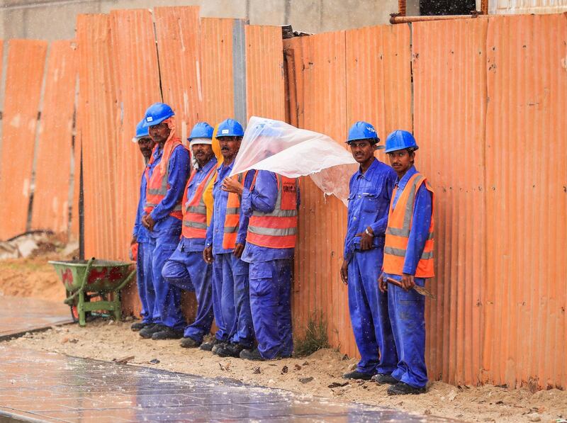 Abu Dhabi, U.A.E., February 2, 2019.   Sudden downpour at Khalifa City, Abu Dhabi.  Workers take cover from the rain during a sudden downpour.
Victor Besa/The National
Section:  NA
Reporter: