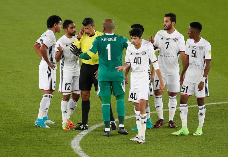 Soccer Football - FIFA Club World Cup Semi Final - Al Jazira vs Real Madrid - Zayed Sports City Stadium, Abu Dhabi, United Arab Emirates - December 13, 2017   Referee Sandro Ricci with Al Jazira players after Real Madrid scored a goal that was eventually disallowed   REUTERS/Amr Abdallah Dalsh