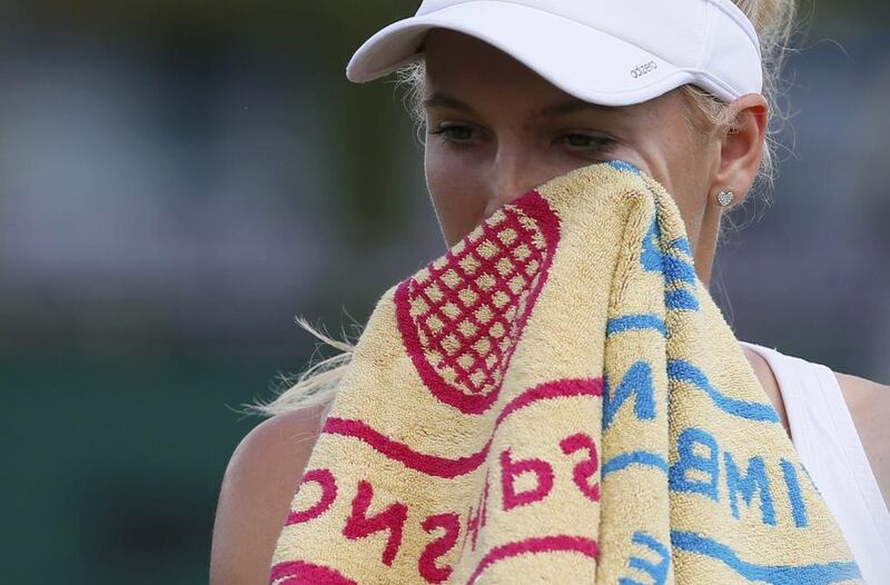 Caroline Wozniacki of Denmark wipes her face during her singles match against Barbora Zahlavova Strycova on Monday at the 2014 Wimbledon Championships. She lost the match in straight sets. Stefan Wermuth / Reuters