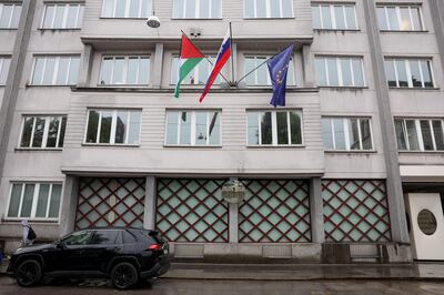 A Palestinian flag flies next to a Slovenian and a European Union flag at a government building in Ljubljana. Reuters 