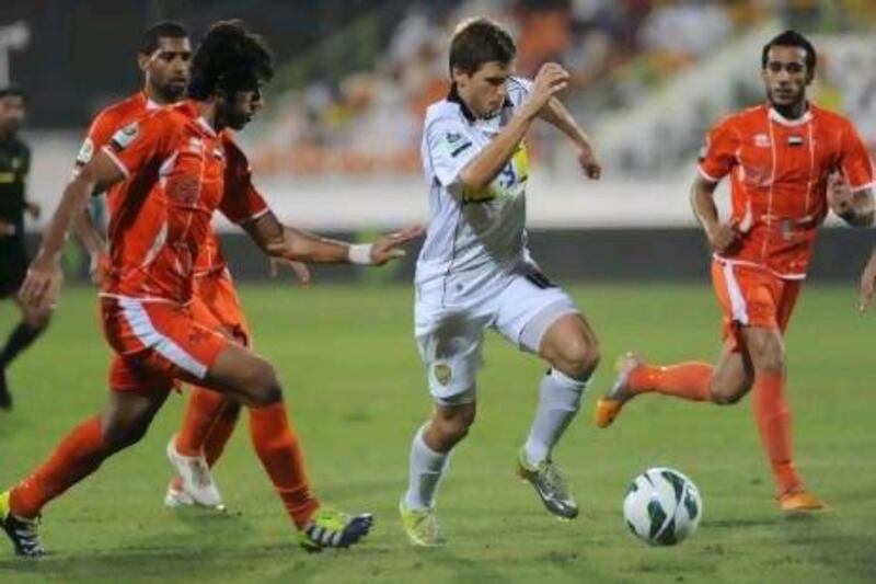 Ajman defenders try to stop Shikabala from forging ahead at the Saeed Stadium.