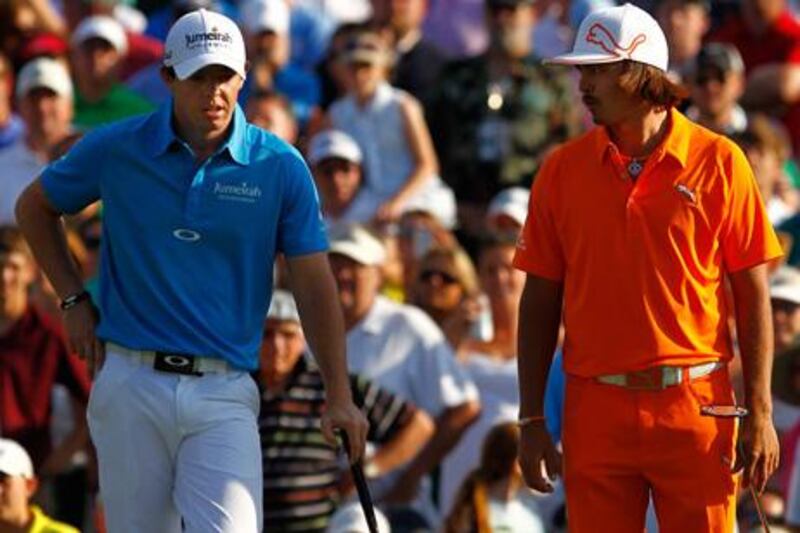 CHARLOTTE, NC - MAY 06: Rickie Fowler (R) of the United States and Rory McIlroy (L) of Northern Ireland stand on the green of the first playoff hole during the final round of the Wells Fargo Championship at the Quail Hollow Club on May 6, 2012 in Charlotte, North Carolina.   Streeter Lecka/Getty Images/AFP== FOR NEWSPAPERS, INTERNET, TELCOS & TELEVISION USE ONLY ==


