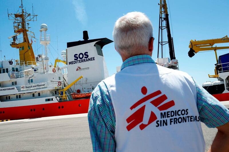 (FILES) In this file photo taken on June 20, 2018 a member of Doctors Without Borders (MSF) looks at the Aquarius rescue vessel, chartered by French NGO SOS-Mediterranee and Doctors Without Borders (MSF) docked at the port of Valencia before the ship´s departure. Humanitarian group SOS Mediterranee said on July 21, 2019 it has relaunched migrant rescue operations off Libya, seven months after it was forced to abandon efforts using its ship Aquarius. SOS Mediterranee and Doctors Without Borders (MSF) "are back at sea with a new vessel, the Ocean Viking, to conduct search and rescue activities in the central Mediterranean", it said. / AFP / PAU BARRENA
