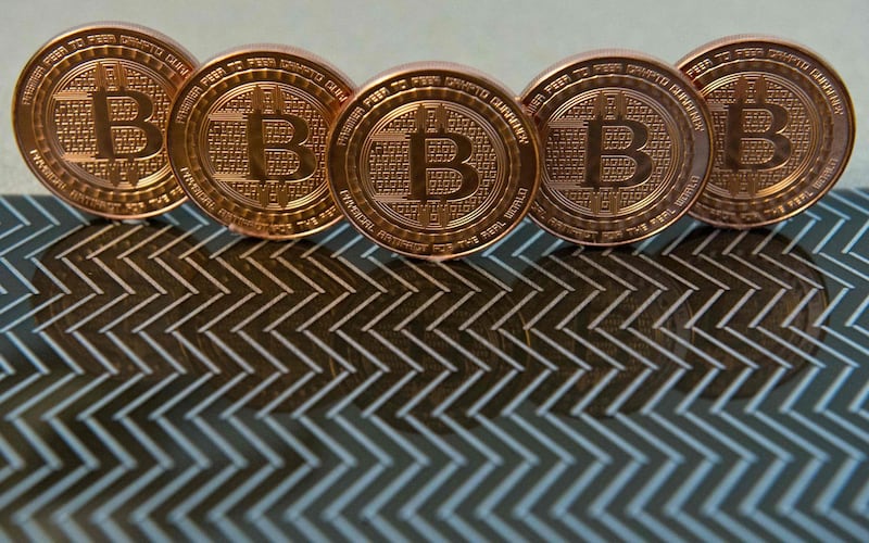 (FILES) This file photo taken on June 17, 2014 in Washington, DC, shows bitcoin medals which use peer-to-peer technology to operate with no central authority or banks; managing transactions and the issuing of bitcoins is carried out collectively by the network.  Cryptocurrency fans have counted Tesla boss Elon Musk as among their champions, but this week he rocked their world by questioning the future of the digital assets and singling out carbon emissions from bitcoin mining for particular criticism. "Energy usage trend over past few months is insane," Musk tweeted on May 13, 2021, sharing a chart from the Cambridge Bitcoin Electricity Consumption Index (CBECI), his latest missive in a salvo that's caused bitcoin's price to drop.
 / AFP / KAREN BLEIER
