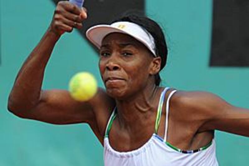 Venus Williams returns the ball during her defeat to the Hungarian No 29 seed Agnes Szavay.