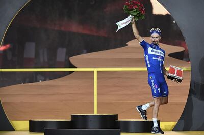 France's Julian Alaphilippe celebrates his prize for day's most combative rider on the podium of the 21st and last stage of the 106th edition of the Tour de France cycling race between Rambouillet and Paris Champs-Elysees, in Paris on July 28, 2019.  / AFP / Anne-Christine POUJOULAT            
