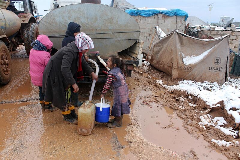 IDLIB, SYRIA - JANUARY 11: Syrian refugees, fled their homes due to the attacks of Assad's forces, try to hold on life under harsh living conditions at the Atmeh refugee camp in Idlib, Syria on January 11, 2015. (Photo by Ahmed Hasan Ubeyd/Anadolu Agency/Getty Images)