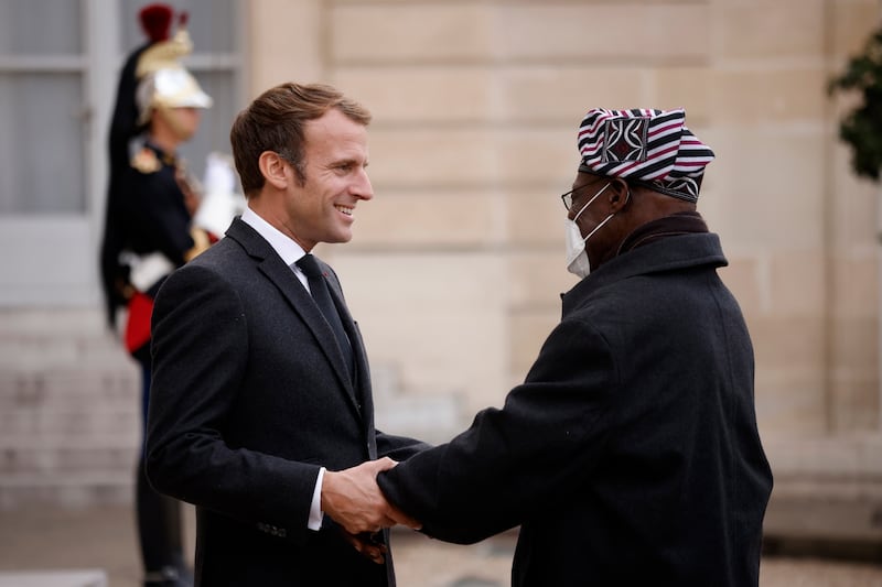 French President Emmanuel Macron welcomes Mr Obasanjo  upon his arrival at the Elysee Palace in Paris, France. EPA