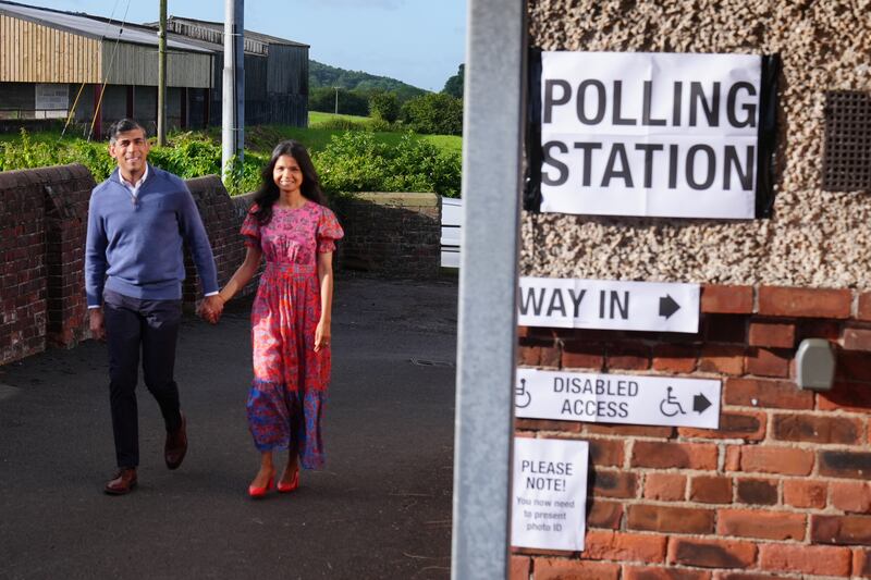 Prime Minister Rishi Sunak and his wife, Akshata Murty, arrive to cast their votes at Kirby Sigston Village Hall in Northallerton, North Yorkshire. PA