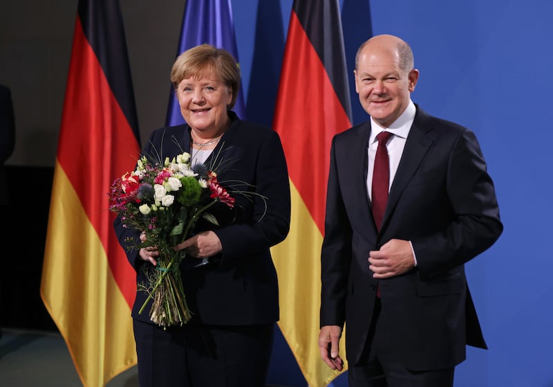German Chancellor Olaf Scholz and former chancellor Angela Merkel during the official transfer of office on December 8, 2021 in Berlin. Getty Images