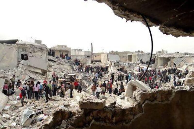 People search the rubble for dead bodies and injured victims at a site were houses were hit by a missile attack by Syrian government forces in Aleppo on Tuesday. Aleppo Media Center AMC / AP Photo