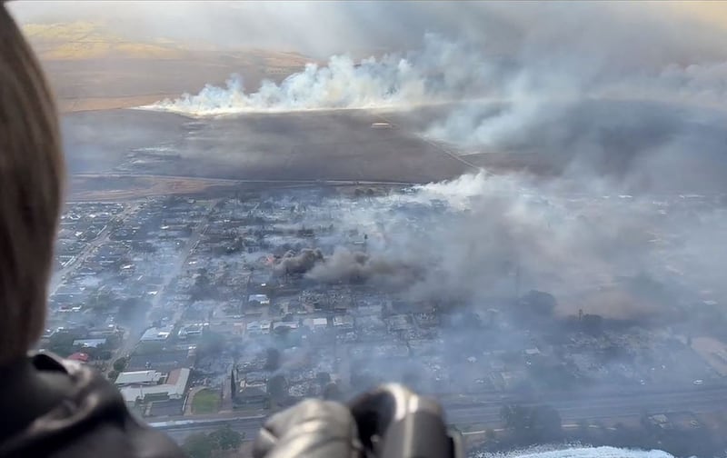 This handout videograb courtesy of Richard Olsten shows smoke billowing from destroyed buildings in Maui. AFP