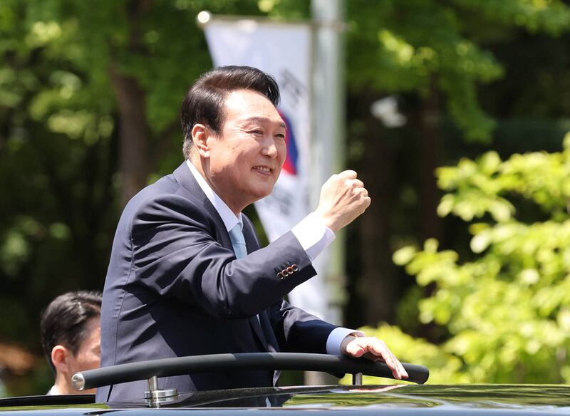 Mr Yoon waves to supporters after his inauguration. Reuters