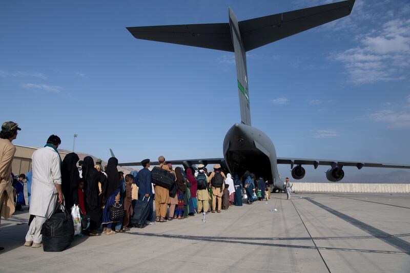 US Air Force staff load passengers aboard an evacuation flight in Kabul on August 14. Reuters