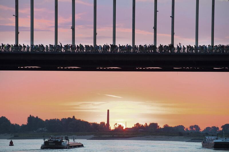 Participants cross a bridge, over the river Waal, during the first day of the 102th edition of the annual Four Days Marches Nijmegen, in Nijmegen, Netherlands. Piroschka van de Wouw/EPA