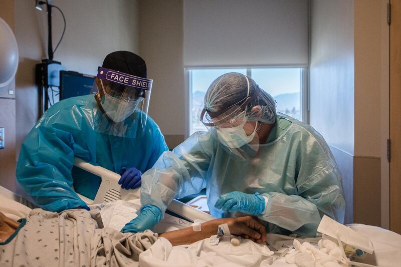 Healthcare workers treat a Covid-19 patient in a Step Down Unit at Providence Holy Cross Medical Center in Mission Hills, California, US. Bloomberg