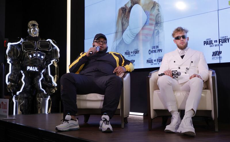 Jake Paul's mascot The Problem Bot looks on as comedian Drew "Druski" Desbordes and Paul speak to reporters. AFP