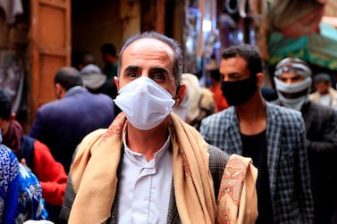 People wear protective face masks against the novel coronavirus at an open-air market in Yemen's rebel-held capital Sanaa. AFP