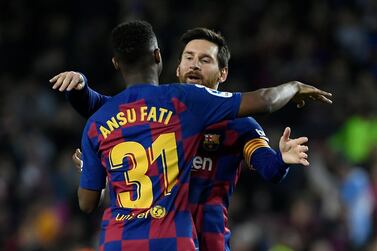 Barcelona's Ansu Fati celebrates with Lionel Messi after scoring against Levante at the Camp Nou. AFP