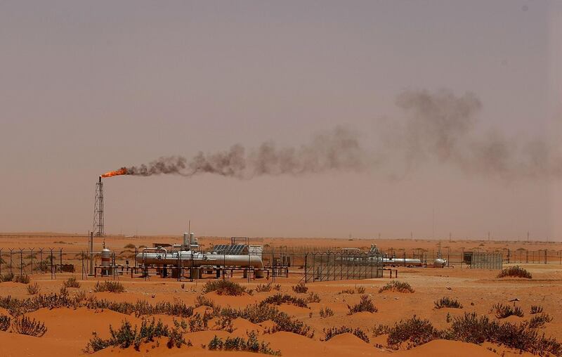 (FILES) In this file photo taken on June 23, 2008, a flame from a Saudi Aramco oil installion known as "Pump 3" is seen in the desert near the oil-rich area of Khurais, 160 kms east of the Saudi capital Riyadh. Saudi state-owned energy giant Aramco said on August 12 that its first half net income for 2019 had slipped to $46.9 billion, a first such disclosure for the secretive company ahead of its debut earnings call. "The company's net income was $46.9 billion for the first half (of) 2019, compared to $53.0 billion for the same period last year," the company said in a statement. The fall in income, owing to lower oil prices, comes amid renewed speculation the company was preparing for its much-delayed overseas stock listing. / AFP / MARWAN NAAMANI
